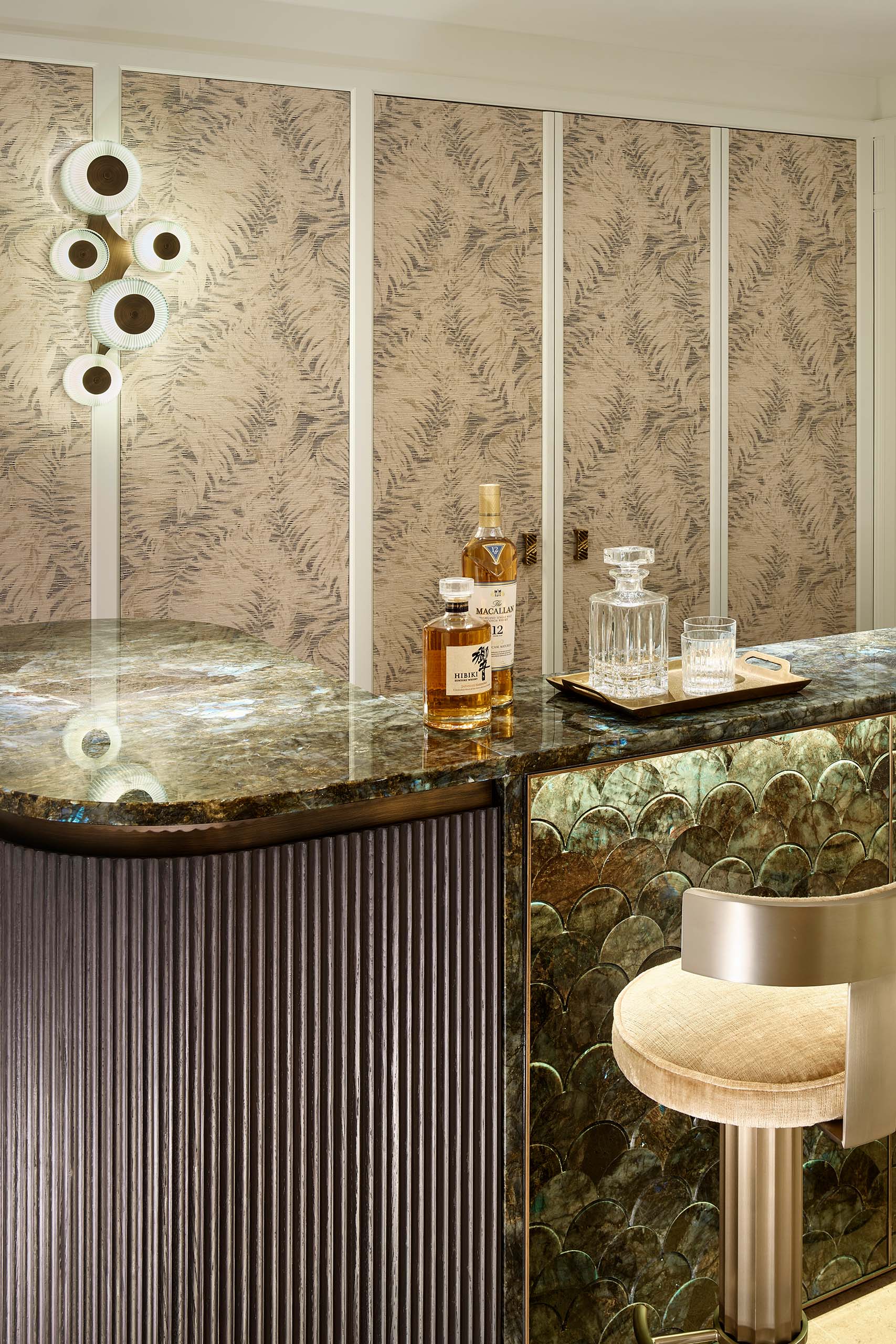 Private bar at Domaine de la Belle Étoile with green marble counter, scallop-tile detail and botanical wallpaper panels
