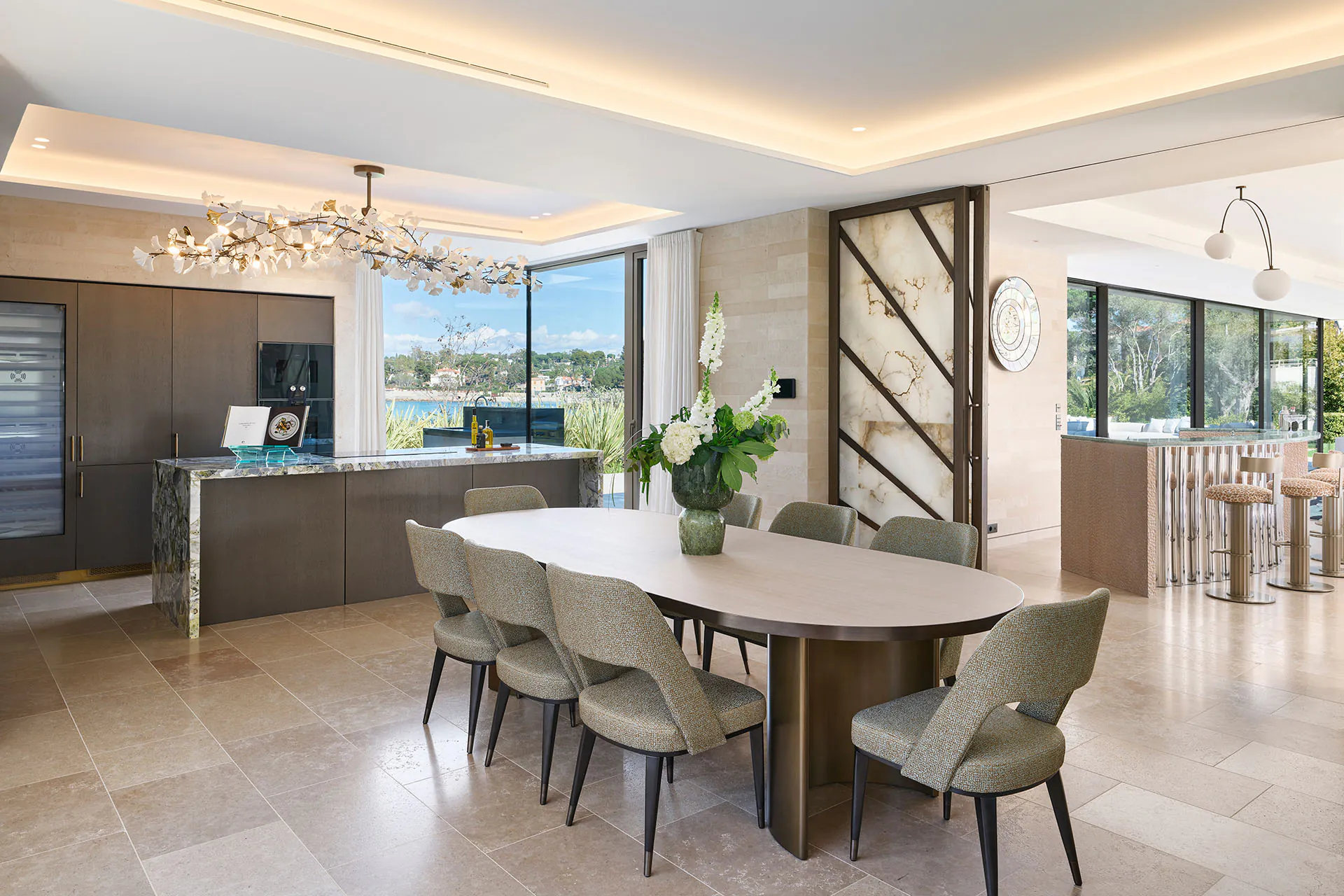 Open-plan kitchen and dining room at Domaine de la Belle Étoile with marble island and direct sea views