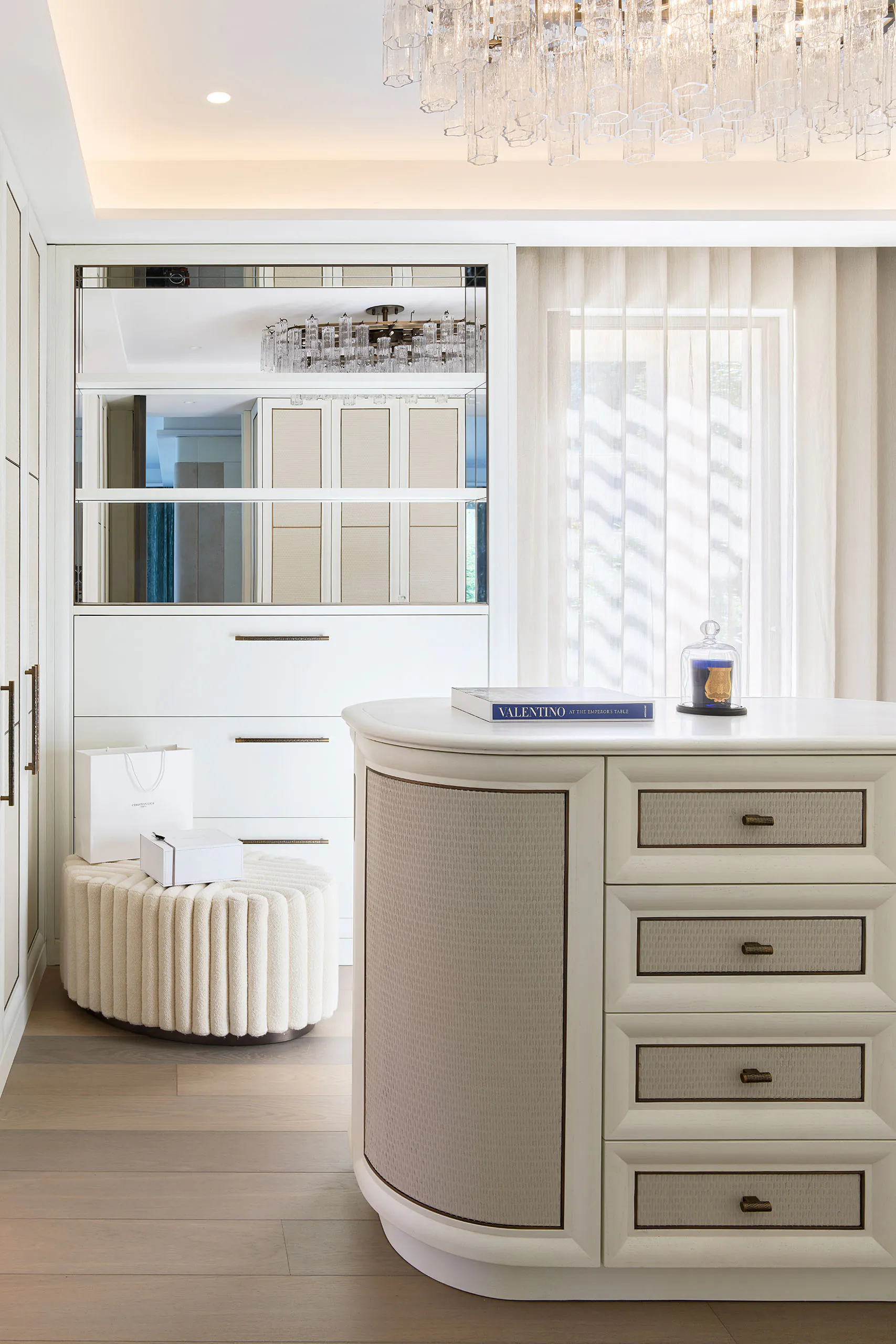 Luxury dressing room at Domaine de la Belle Étoile with fitted wardrobes, mirrored cabinetry and crystal chandelier