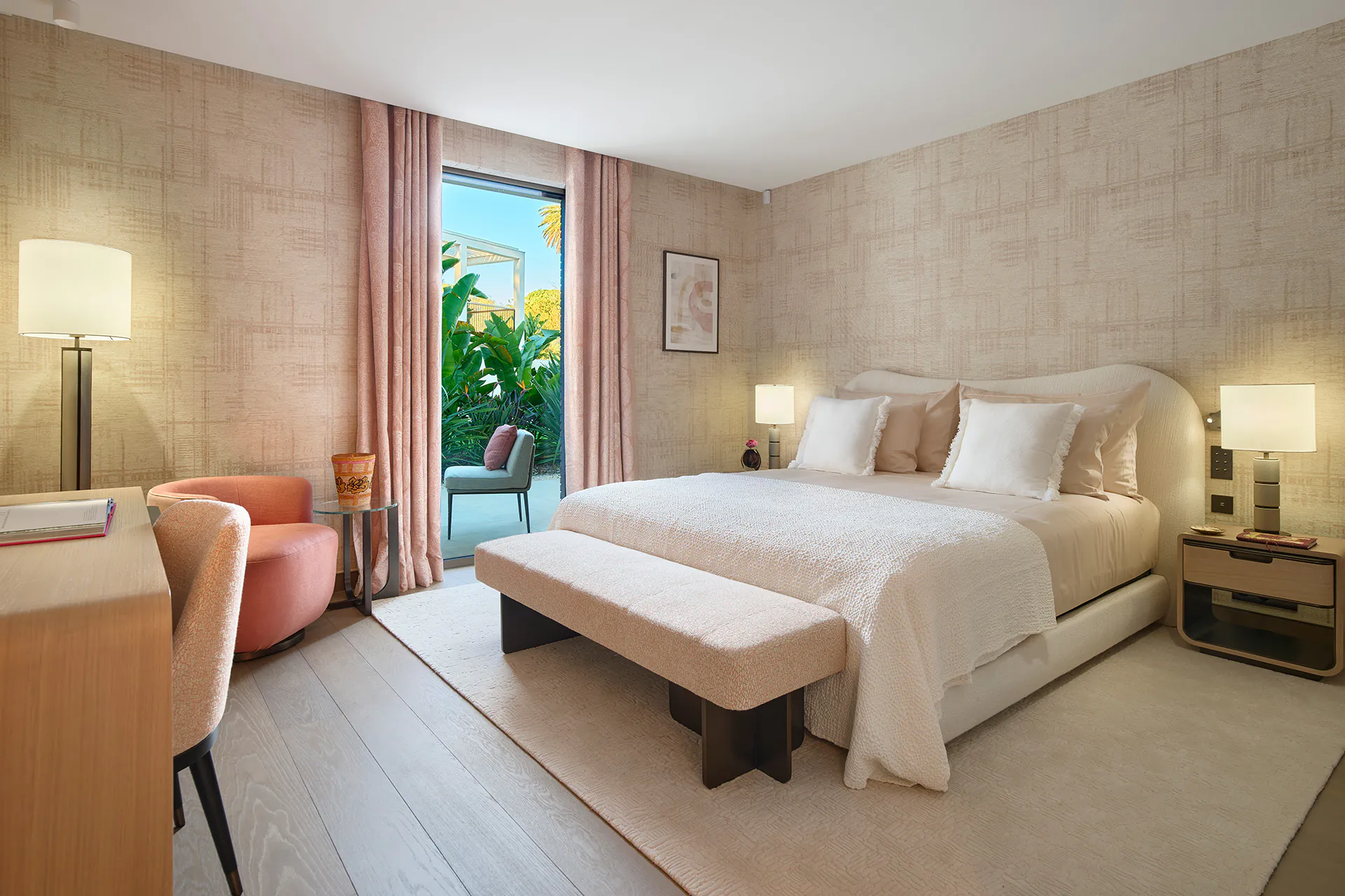 Guest bedroom at Domaine de la Belle Étoile with curved upholstered headboard, pink curtains and private terrace access
