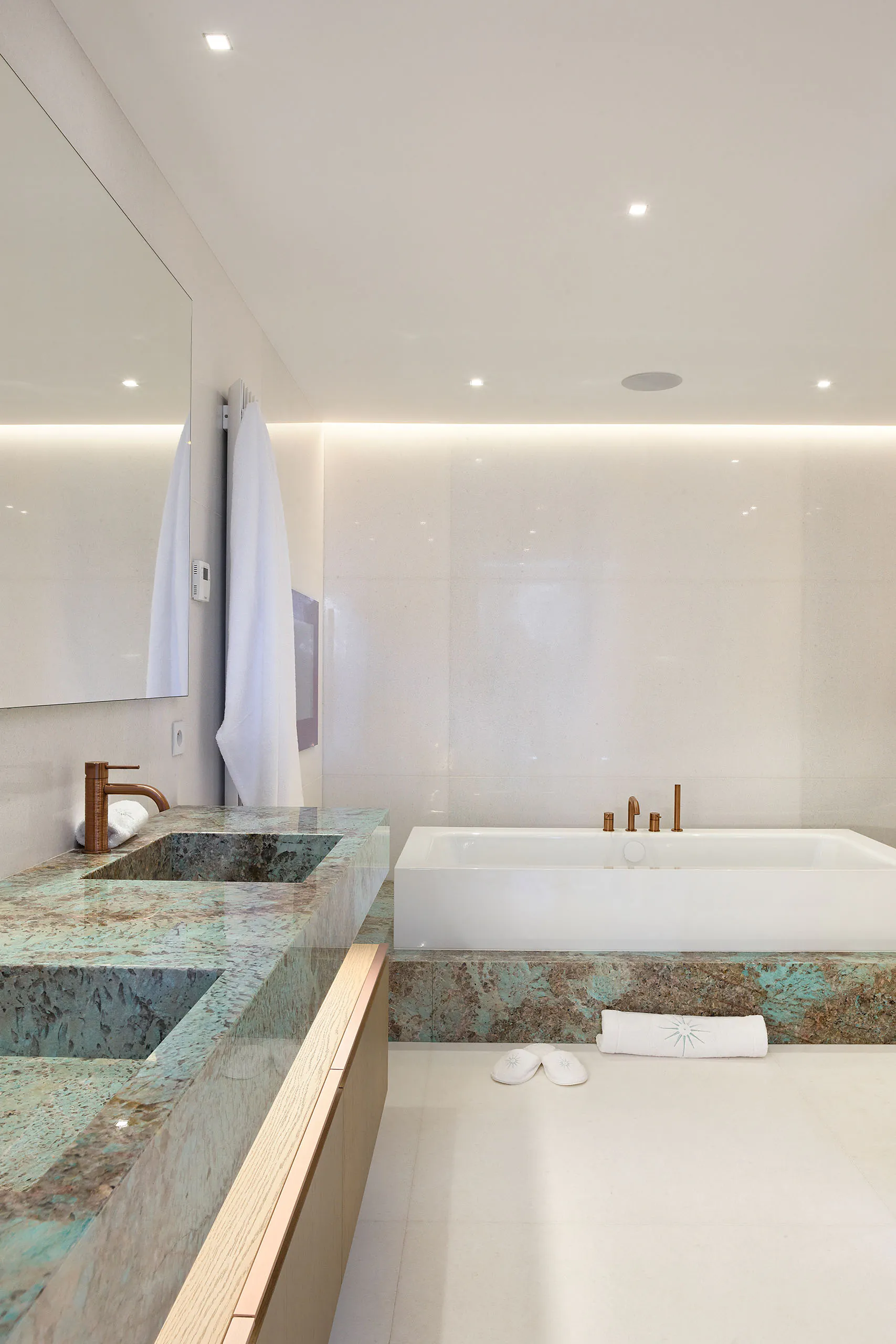 Luxury en-suite bathroom at Domaine de la Belle Étoile with green marble vanity, copper taps and freestanding bath
